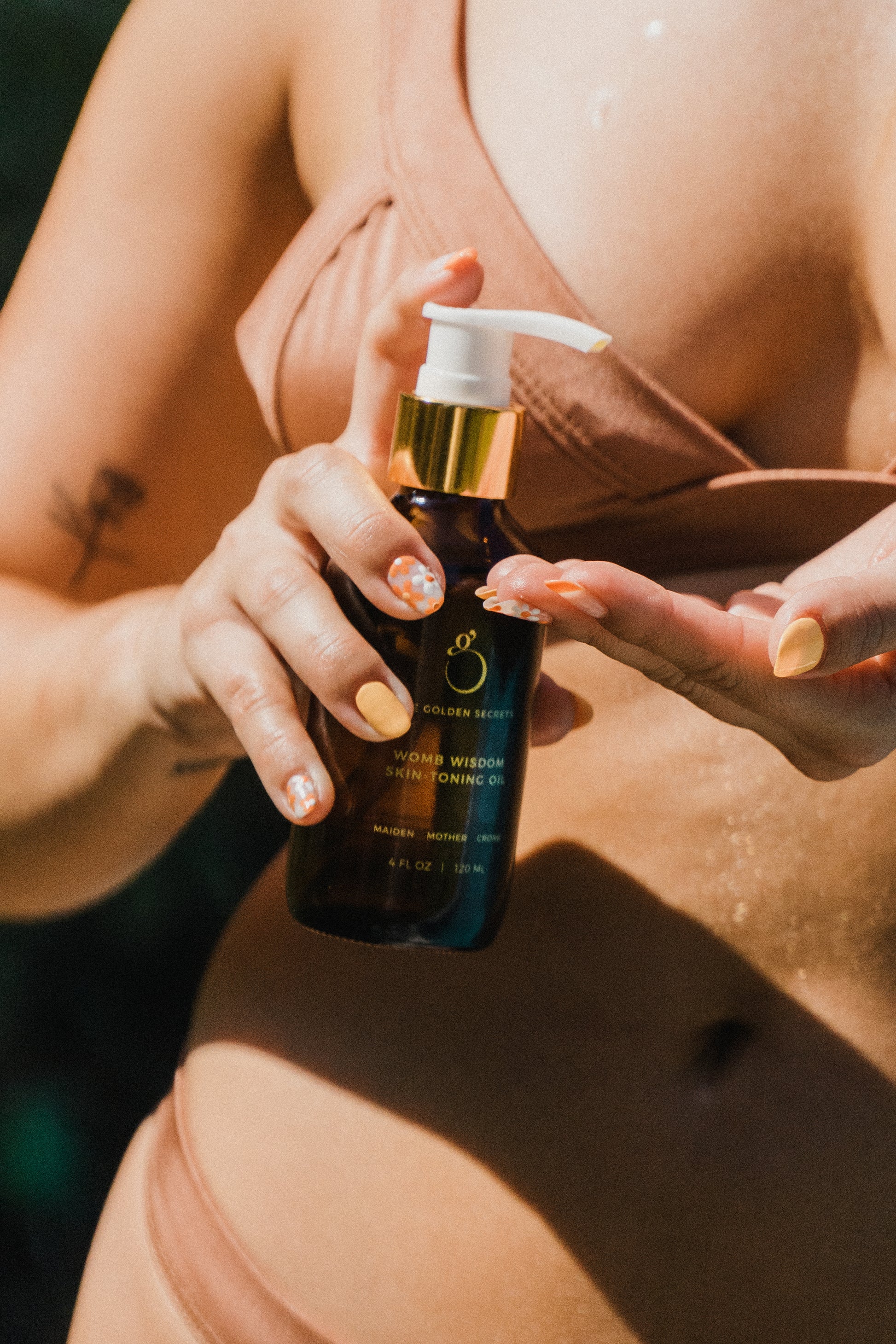 Lifestyle image of Womb Wisdom Skin-Toning Oil, showing a serene, nurturing moment.